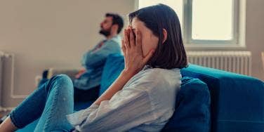 heartbroken woman on couch with man