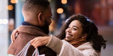 smiling woman hugging man