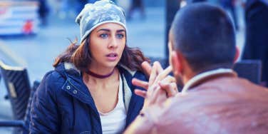 woman looking confused and up set that boyfriend is breaking up with her