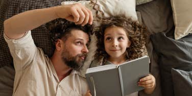 Dad and daughter reading book