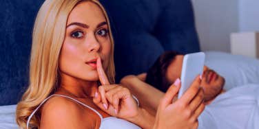 woman secretly on phone cheating