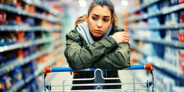 woman looking sad because she doesn't feel loved while she walks through the grocery store