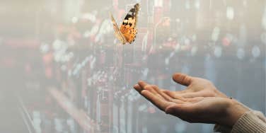 Woman letting go of butterfly, liquor behind her no longer controlling