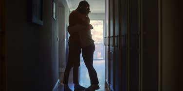 man and woman hugging in hallway