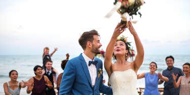 bride throwing bouquet