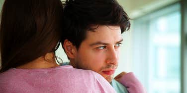 woman hugging unsure boyfriend