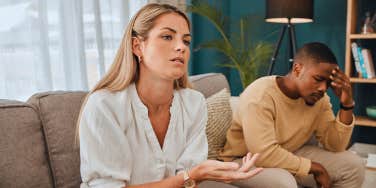 unhappy couple sitting on the couch