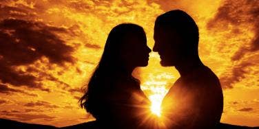 woman and man embracing in sunset
