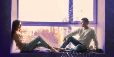 man and woman sitting on a window sill