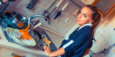 wife annoyed by dirty dishes in the sink