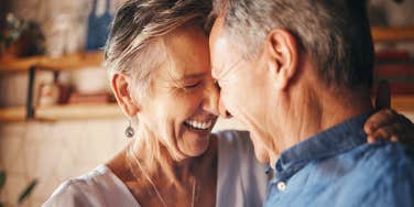 close up portrait of elderly couple laughing and dancing together
