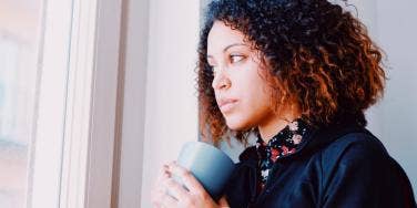 woman staring out the window