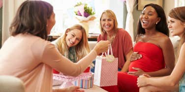friend group giving gifts during baby shower