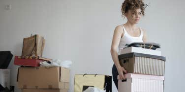 woman holding moving boxes