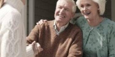 woman shaking hands with elderly couple