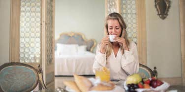 woman eating breakfast at hotel 