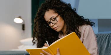 woman writing in a journal 