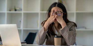 tired business woman sleepy and bored from sitting at a desk for a long time 