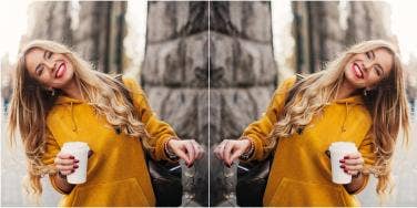 mirror image of woman wearing yellow and holding glasses and coffee cup