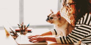 woman working from home with dog