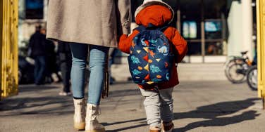 working mom walking her child to daycare