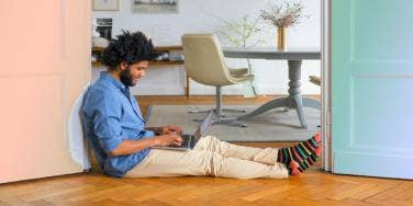 man sitting on the floor with laptop