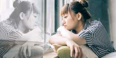 woman lonely looking out window