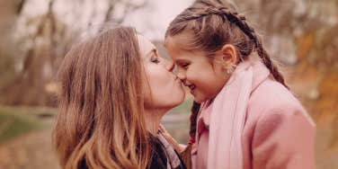 mother kissing her child