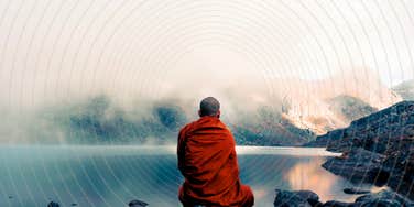 Monk sitting on rock teaching calm, focus and presence