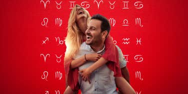 woman and man happily walking piggy back