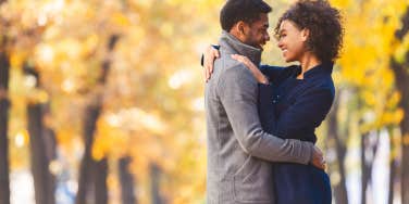 couple wearing winter jackets in the fall