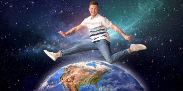 man jumping over planet earth in outerspace