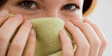 girl hiding behind fabric