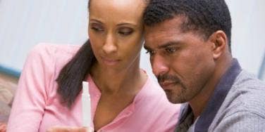 couple looking at pregnancy test