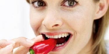 woman eating pepper