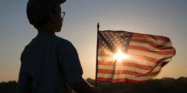 little boy holding a flag