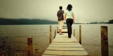couple walking down boardwalk couple walking together