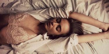 woman on bed in bra woman on bed in bra