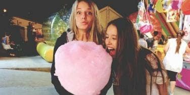 girls eating cotton candy girls eating cotton candy