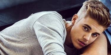 Justin Bieber wearing a long sleeved gray tee
