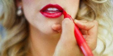 girl applying lip product girl applying lip product