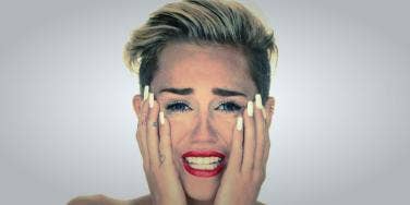 Miley Cyrus naked and crying in her "Wrecking Ball" music video