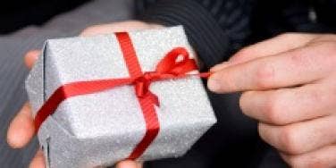 Man's hand opening a Christmas gift