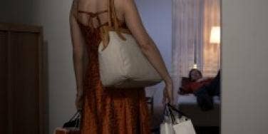 Woman coming home with shopping bags