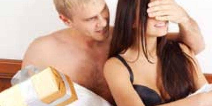 couple in bed with a gift