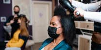 black woman getting hair done in salon