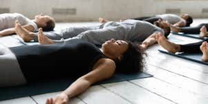 woman grounding herself in Shavasana