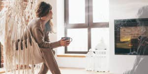 Woman sitting with coffee by fireplace, smell of late mothers perfume moving towards her 