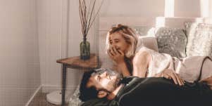 couple laughing together in bedroom