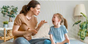 mom trying to reason with her crying inconsolable child